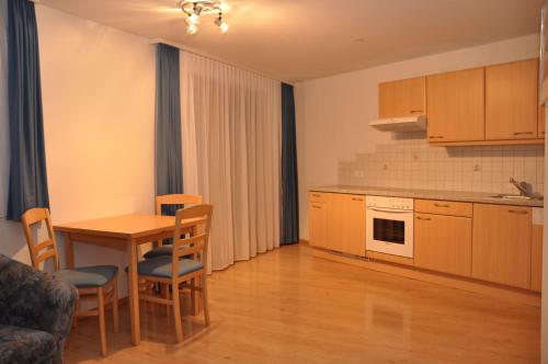 a kitchen with a table and chairs in a room at Haus Gentiana in Samnaun