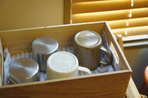 a wooden box with several utensils in it at wanderlust STAY in Kofu