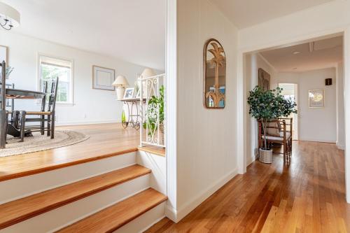 a living room with a staircase and a dining room at Spacious 3 bedroom house 45mins to NYC great hotel alternative for big group in Port Chester