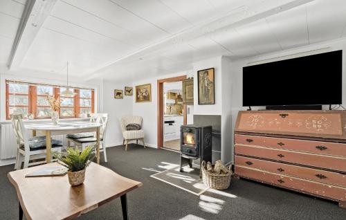a living room with a flat screen tv and a table at Awesome Home In Tim With Wifi in Tim