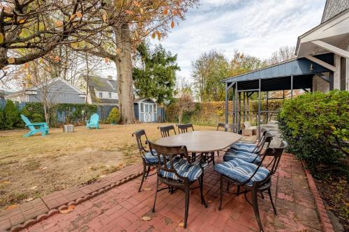 a table and chairs on a brick patio at Spacious 3 bedroom house 45mins to NYC great hotel alternative for big group in Port Chester