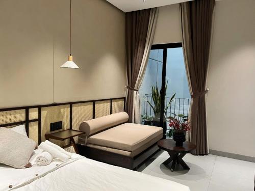 a bedroom with a bed and a chair and a window at Ladyfit House in Thôn Trường Giang