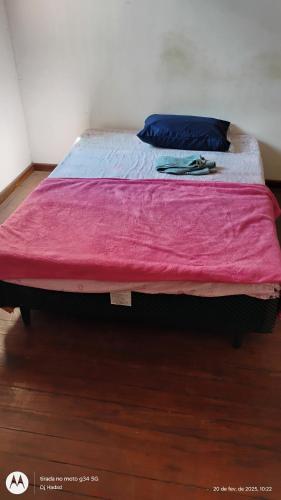 a bed with a pink blanket on top of it at Santa Alexandrina in Rio de Janeiro