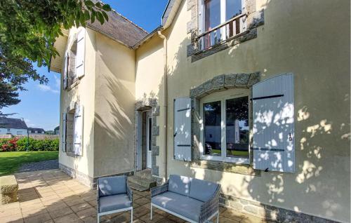 two chairs sitting outside of a house at 3 Bedroom Beautiful Home In Pont-Aven in Pont-Aven