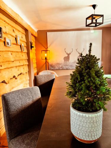a room with a table with a christmas tree on it at La Cabane de Marie in La Bollène-Vésubie
