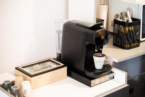 a coffee maker sitting on top of a counter at Appart Standing in Trappes