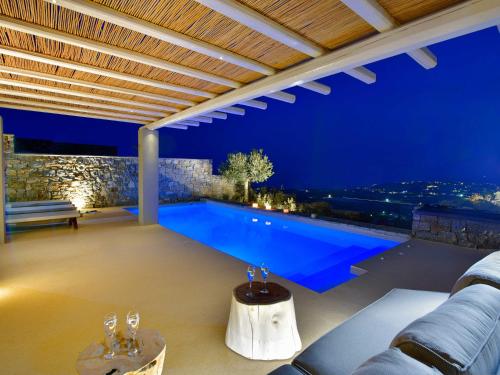 a swimming pool in a villa at night at Mykonos Rocks Villas & Suites in Mýkonos City