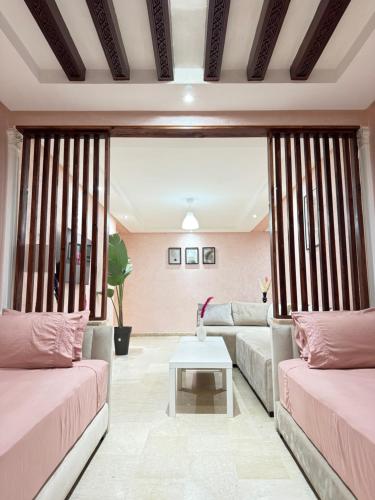 a living room with two couches and a table at SUITOUISS - Agdal 2 - Appartements à 2 minutes de la gare de train TGV Rabat in Rabat