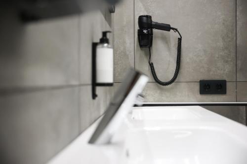 a bathroom with a phone hanging on a wall at KY Mountain Hostel Arinsal in Arinsal
