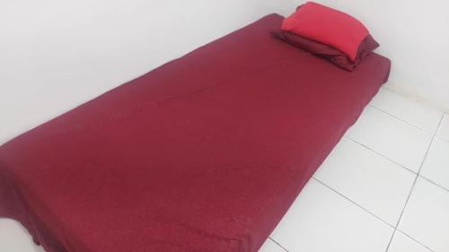 a red pillow sitting on top of a floor at Homestay syariah off in Karawang