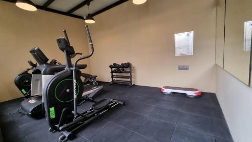 a gym with a treadmill and a exercise bike at Villa 55 in 6th Of October
