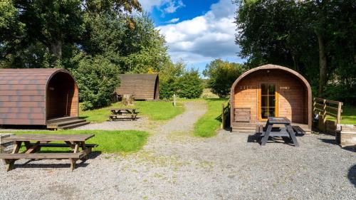 a couple of sheds and picnic tables in a park at Woodclose Park in Kirkby Lonsdale