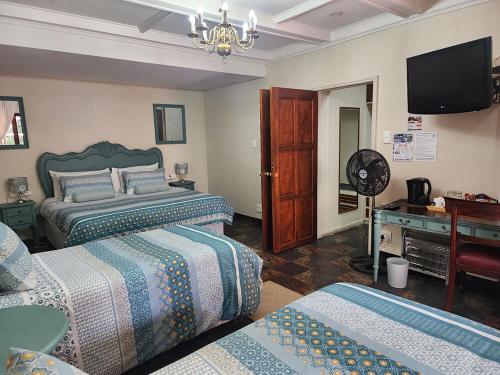 Ένα ή περισσότερα κρεβάτια σε δωμάτιο στο Goodnight Guest Lodge