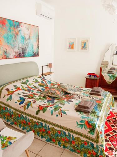 a bed with a colorful quilt on it in a room at La Casa del Belvedere in Perugia