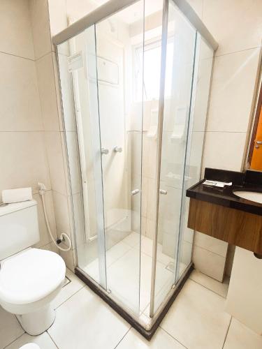 a glass shower in a bathroom with a toilet at Nord Easy Ondas do Atlantico in João Pessoa