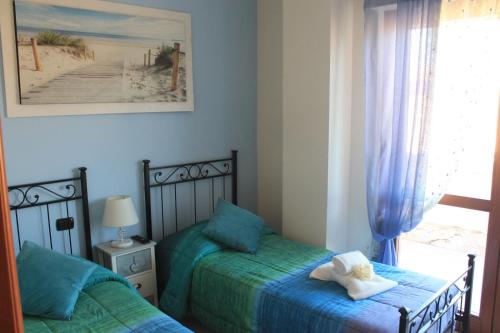 a bedroom with two beds with a stuffed animal on top at Giramondo LuxeFierairport in Fiumicino
