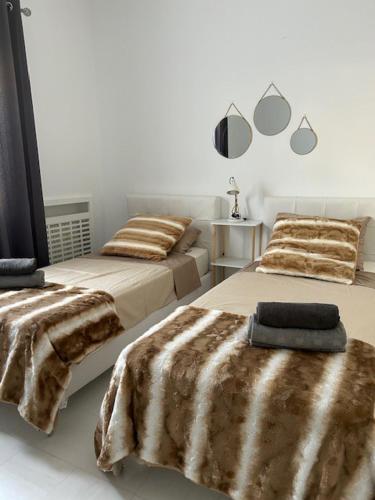 a bedroom with two beds with blankets on them at Very high standing apartment in Gammarth