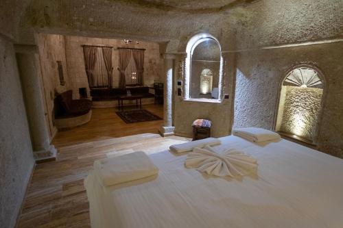 a bedroom with a bed with two white pillows on it at Kemerhan Cave Suites in Urgup