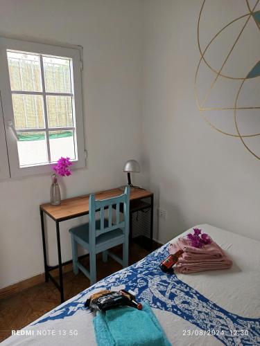 a bedroom with a bed and a desk and a window at Acoran Family Ocean View Guest House With Daily Yoga Practice Included North Gran Canaria PRIVATE ROOM PET FRIENDLY in Firgas