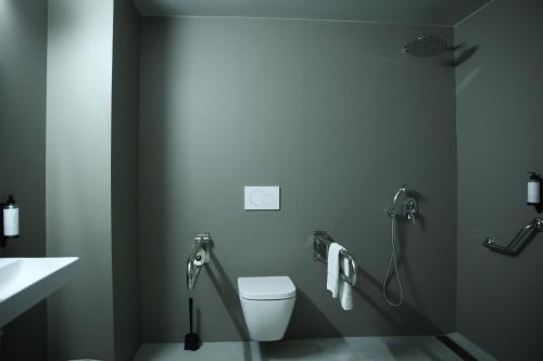 a bathroom with a white toilet and a sink at KY Mountain Hostel Arinsal in Arinsal