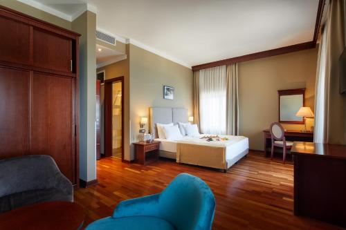 a hotel room with a bed and a living room at BO Hotel Palazzo in Poreč