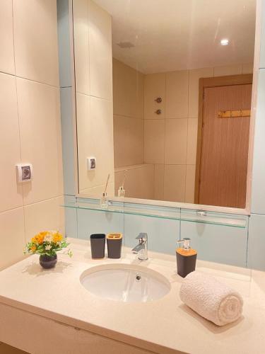Un baño con lavabo y un espejo grande. en Suíte Deluxe Soares, en Prainha