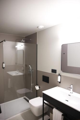 a bathroom with a toilet and a sink and a shower at KY Mountain Hostel Arinsal in Arinsal
