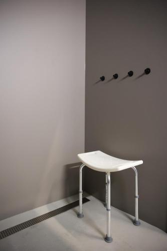 a white table sitting in a corner of a room at KY Mountain Hostel Arinsal in Arinsal