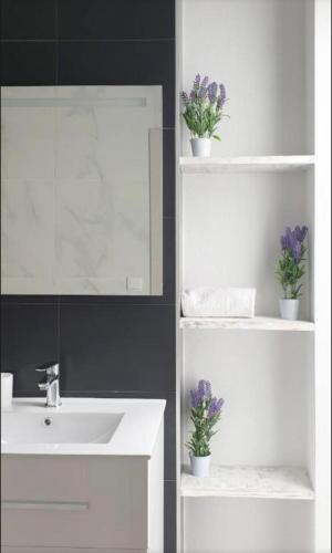 a white bathroom with a sink and a mirror at Olivia Apartments TRG in Benidorm