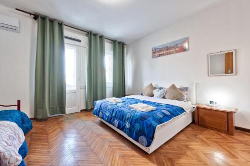 a bedroom with a bed with a blue comforter at Cozy Miranese Venice Apartment in Chirignago