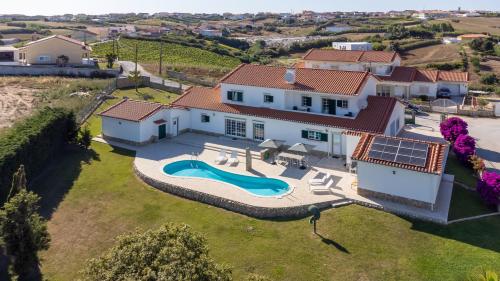 an aerial view of a house with a swimming pool at Villa Casa Branca in Ribamar