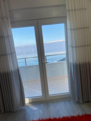 a room with two large windows with a view of the ocean at Jurgen House in Piskupat