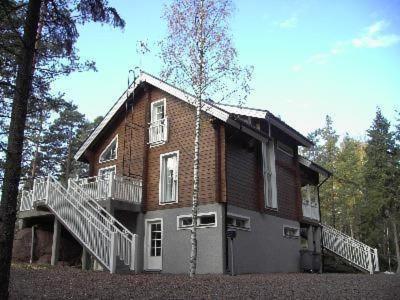 a brick house with a staircase in front of it at Ferienhaus Für 10 Personen In Loviisa, Uusimaa in Lovisa