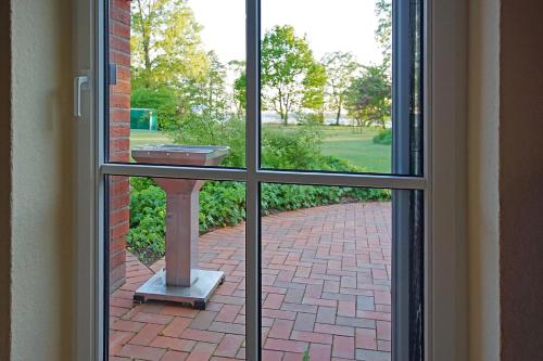 a view from a window of a brick walkway at Ferienhaus Seegang Mit Eingezäuntem Grundstück in Flessenow