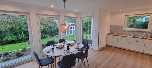 a kitchen and dining room with a table and chairs at Ferienhaus Knoke Ii in Marienmünster