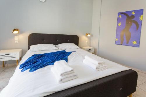a bedroom with a bed with towels on it at Wohnung In Kato Gouves Mit Gemeinschaftspool in Kato Gouves