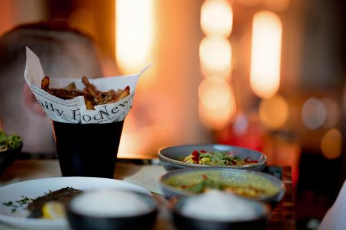 a table with two plates of food and a glass of soda at Coquillade Provence - Relais & Châteaux in Gargas