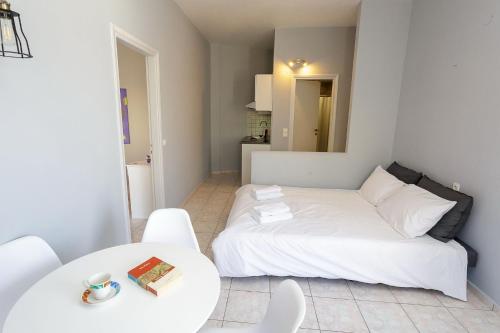 a bedroom with a bed and a table and chairs at Wohnung In Kato Gouves Mit Gemeinschaftspool in Kato Gouves