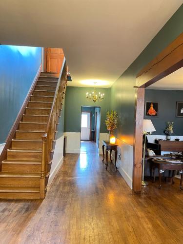a living room with stairs and a dining room at The Yorkshire Inn in Phelps