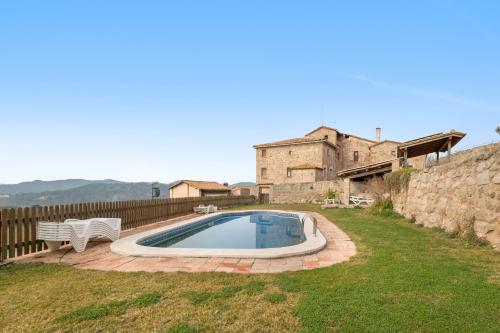 a swimming pool in a yard next to a building at El Baluard De Ferreres in Olvan