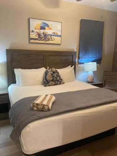 a bedroom with a large bed with an umbrella at Bleu Beach Resort in Indialantic