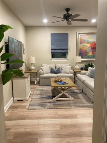 a living room with a couch and a table at Bleu Beach Resort in Indialantic