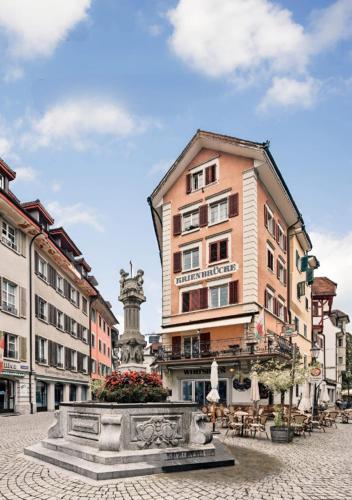 a city square with a fountain in front of a building at KB CityRooms Self-Check-In in Luzern