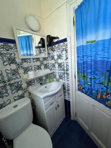 a bathroom with a toilet and a sink and a mirror at Balcon del Alba VUT N1238 in Lastres