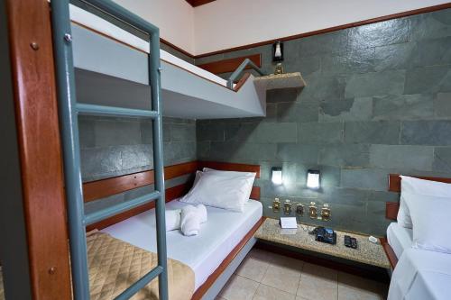 a bunk bed in a room with a ladder at SESC ARAXÁ in Araxá