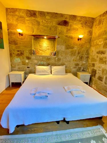 a bedroom with a large bed with two towels on it at Otel Kallista in Alacati