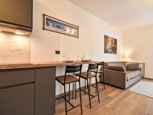 a bar in a room with chairs and a couch at Studio San Anton by Interhome in Bormio