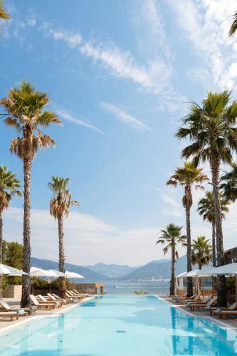 basen z palmami i widokiem na ocean w obiekcie Monte Palm Beach w mieście Tivat