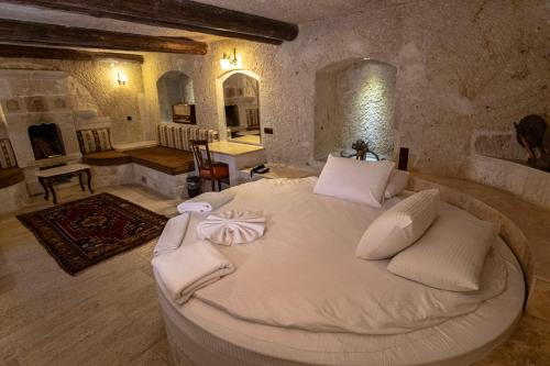 a bedroom with a large white bed in a room at Kemerhan Cave Suites in Urgup
