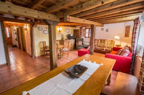 a living room with a wooden table and a living room at Anticca Rural hasta 4 personas in Atauta